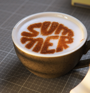 Café com desenho de canela na espuma